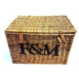 A RECTANGULAR WICKER PICNIC HAMPER by Fortnum & Mason, with pair of carrying handles and leather