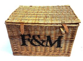 A RECTANGULAR WICKER PICNIC HAMPER by Fortnum & Mason, with pair of carrying handles and leather