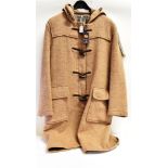 A 'GLOVERALL' DUFFLE COAT in fawn and a similar cream coat (2)