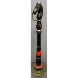 A CAST IRON PAINTED HORSE TETHER formed as a horse's head with tethering ring, the painted pillar on