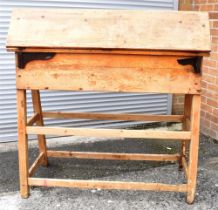 A PINE SADDLE HORSE the hinged top opening to reveal a work surface supported by four hinged