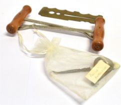 A PAIR OF BOOT PULLS a brass button polishing guard and two button hooks