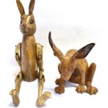 A WOODEN JOINTED FIGURE OF A HARE height 70cm and a ceramic figure of a seated hare, height 30cm (