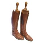 A PAIR OF BROWN LEATHER POLO BOOTS with zip fronts, size 10-10 ½ complete with trees