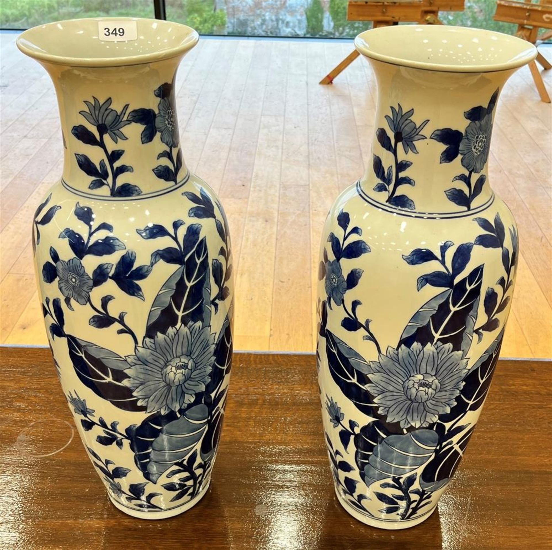 BLUE AND WHITE TALL VASES WITH FLORAL DECORATION