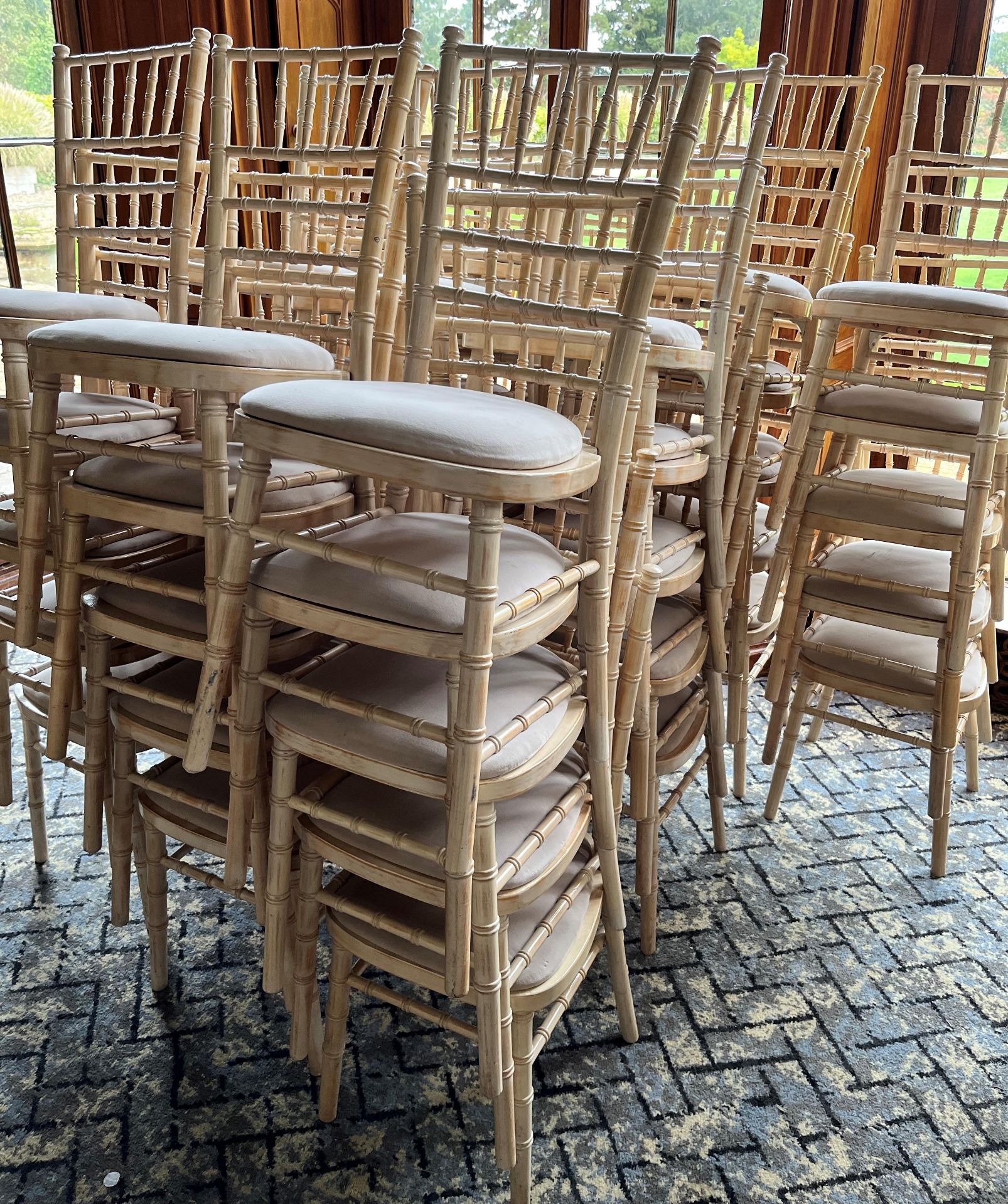 A QUANTITY OF WHITE STACKING CHAIRS