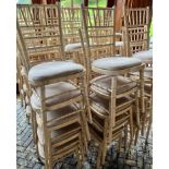 A QUANTITY OF WHITE STACKING CHAIRS