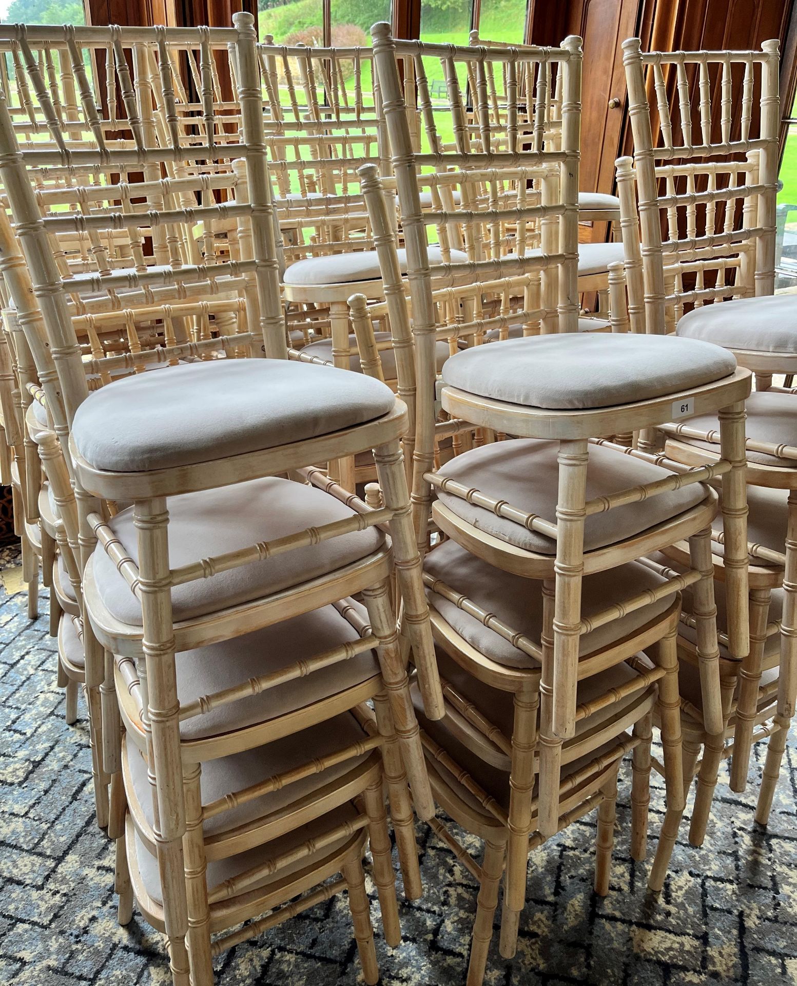 A QUANTITY OF WHITE STACKING CHAIRS