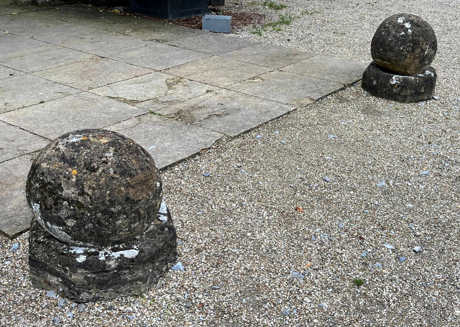 TWO SANDSTONE SPHERES ON PLINTHS