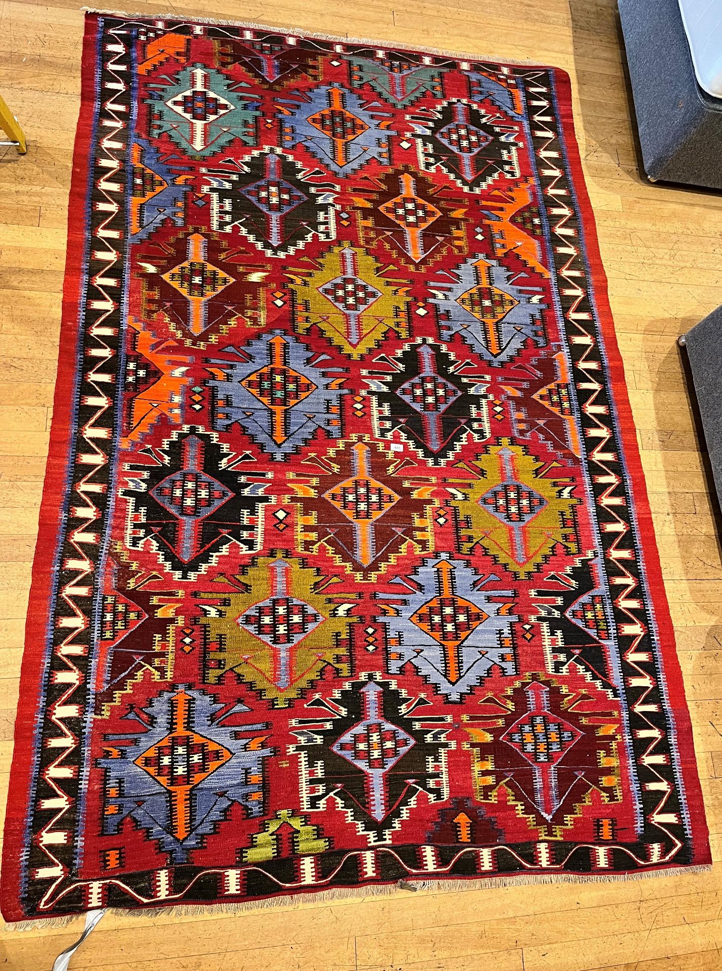 LARGE RUG ON A RED GROUND