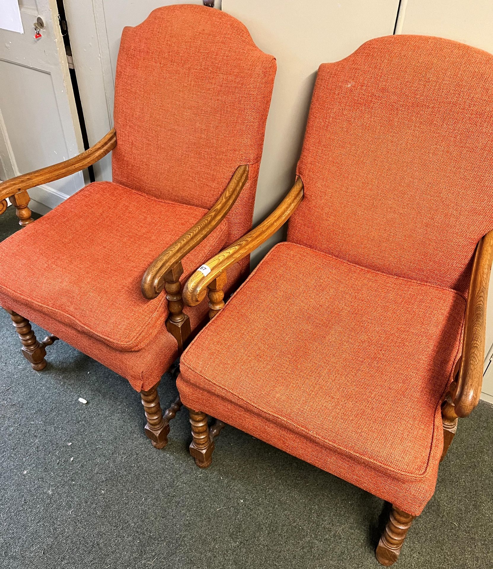 TWO ARMCHAIRS WITH ORANGE COVERS