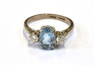 18CT AQUAMARINE & DIAMOND RING Central oval mixed cut aquamarine, estimated 1.1 carats, flanked by