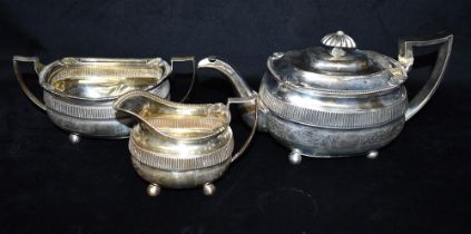 GEORGIAN SILVER TEA SERVICE Comprising teapot, sugar bowl and cream jug, all of oval form on orb