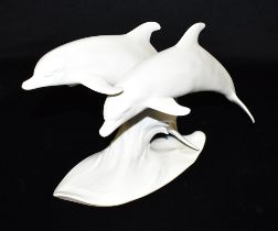 A KAISER BISQUE PORCELAIN GROUP OF TWO LEAPING DOLPHINS model 509, with transfer printed and