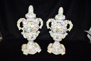 A PAIR OF GERMAN FLORAL ENCRUSTED LIDDED VASES 20th century, with gilded decoration, the bases