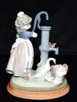 A LLADRO FIGURAL GROUP 'SUMMER ON THE FARM' model no.5285, depicting a girl and birds at a water