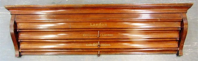 AN EDWARDIAN MAHOGANY WALL-MOUNTED MAP CASE containing pull-down maps of London (drawn for the