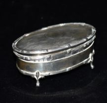 GEORGE V SILVER PATCH BOX By Mappin & Webb, of oval form, on fleur de lys topped pad feet, engine