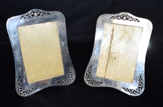 GEORGE V SILVER PICTURE FRAMES A pair of silver mounted picture frames decorated with pierced scroll
