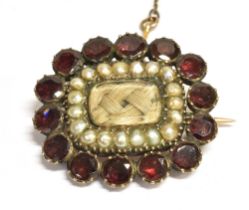 GEORGIAN PEARL & GARNET MOURNING BROOCH Approx 26.4 x 23.5mm, with a central locket of plaited