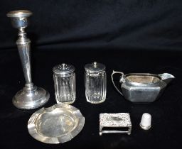 VARIOUS SILVER ITEMS To include a single silver candlestick, thimble, ashtray, Art Deco cream jug,