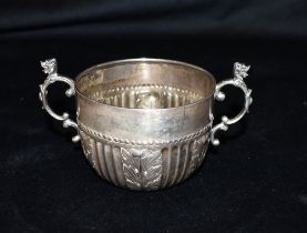 VICTORIAN SILVER MUG Stands 6.0cm high, decorated with embossed Acanthus leaves, scroll and