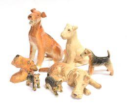 SEVEN CERAMIC AIREDALE TERRIER ORNAMENTS including one by Sylvac, 18cm long; and one by Beswick,