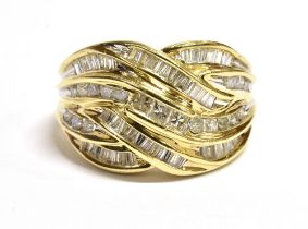 9CT GOLD & DIAMOND DRESS RING An interlocking ribbon style head, channel set with round brilliant