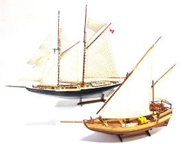 TWO MODEL BOATS comprising the Canadian gaff rigged schooner 'Bluenose', 50cm long (inclusive of