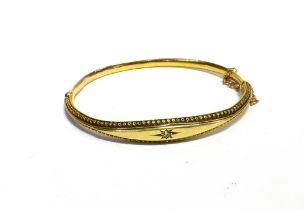 ANTIQUE 15CT GOLD BANGLE 7.5-4.1mm tapering front, with cannetille work to sides and a central