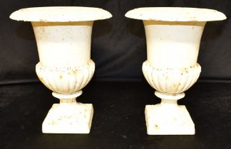 A PAIR OF PAINTED CAST METAL CAMPANA URNS 20th century, 30cm high.