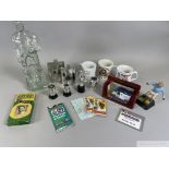 A box of miscellaneous football memorabilia including glass footballer, hip flasks etc