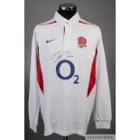 A white England rugby jersey signed by Martin Johnson