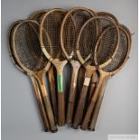 A collection of 22 wooden framed concave-wedge tennis racquets,