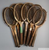 A collection of 22 wooden framed concave-wedge tennis racquets,