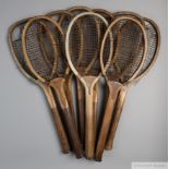 A collection of 14 wooden framed convex-wedge tennis racquets,