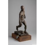 A bronze tone resin sculpture of Pelé kicking a soccer ball and wearing his No.10 shirty