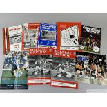 A large box of assorted football programmes,