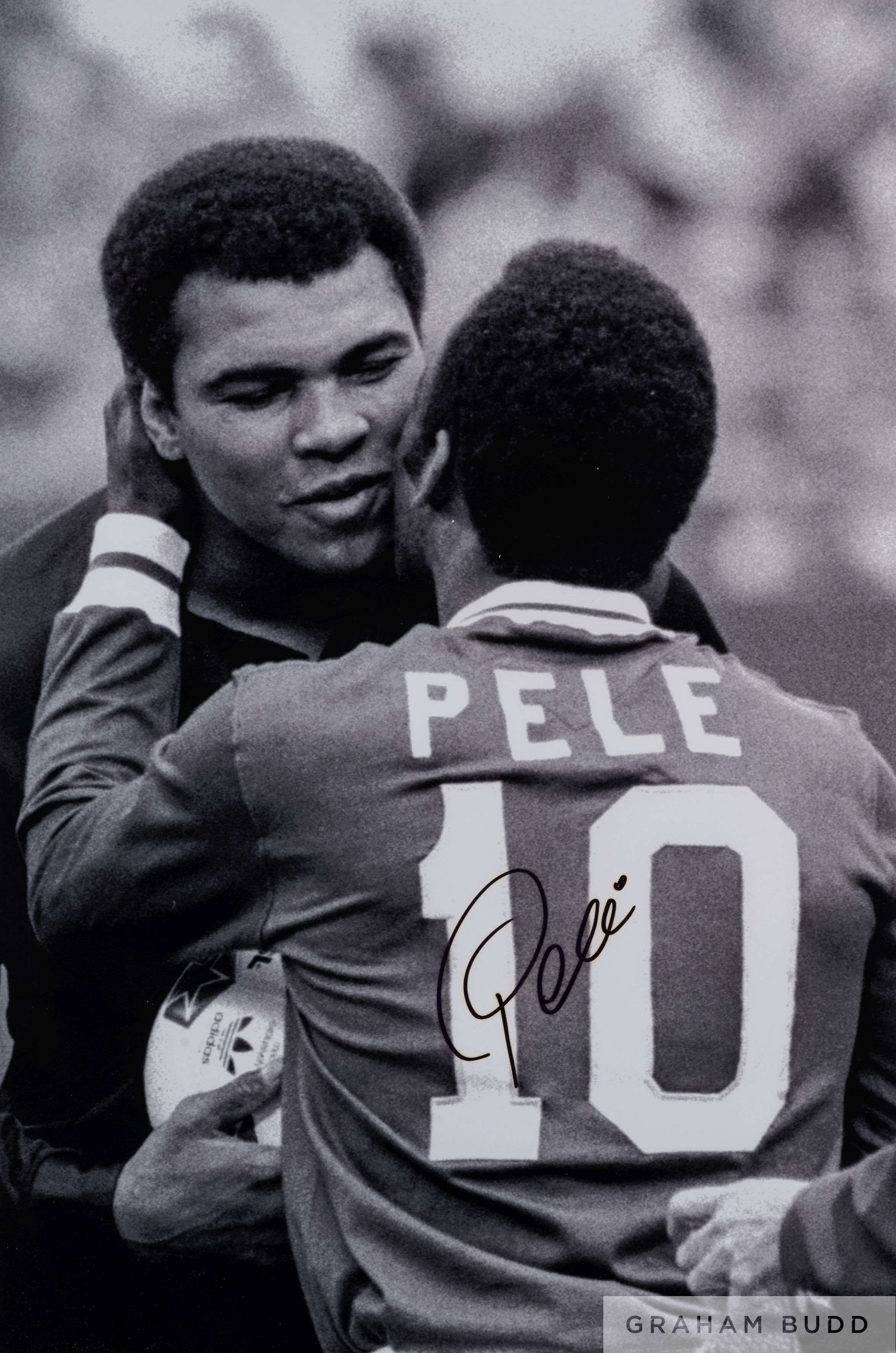 A large black and white portrait photograph of Pele embracing Muhmmed Ali