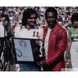 A large colour portrait photograph of Pele and George Best