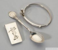 A silver golf bangle, money clip and teaspoon
