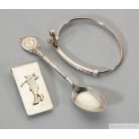 A silver golf bangle, money clip and teaspoon