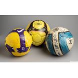 A group of three match issued footballs
