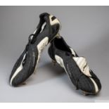 A Pair of black and white Umbro size 10.5 exo skeleton football boots