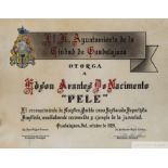 A framed hand drawn and hand colored certificate of merit on vellum presented to Pelé