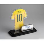 A trophy featuring a picture of Pelé's Brazil national football team jersey
