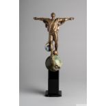 A trophy owned by Pelé featuring a bronze portrait of himself with arms outstretched