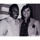 A large black and white portrait photograph of Pele and George Best