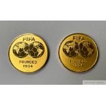 A pair of gold tone medallions presented to Pelé at an exhibition match between Italy and Argentina