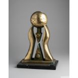 A trophy presented to Pelé composed of a marble base mounted by a stylized pair of hands holding alo